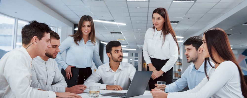 Conception of success. Group of young freelancers in the office have conversation and smiling.